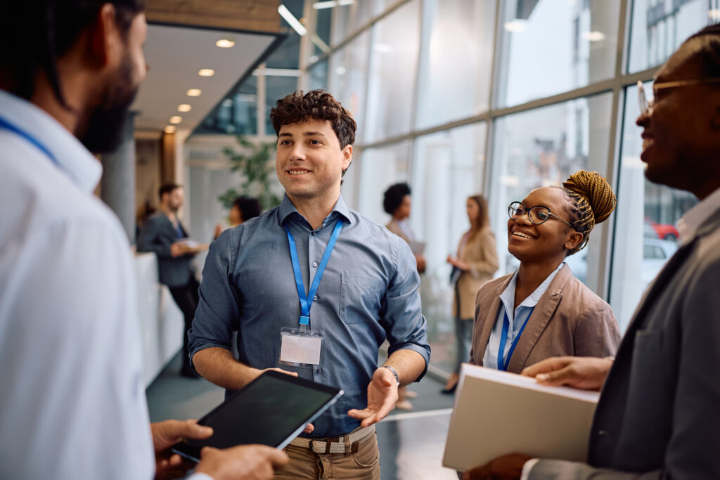 Employees interact with visitors at their trade show booth