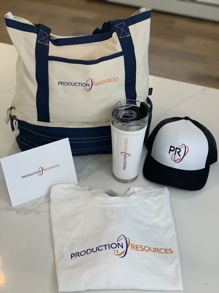 Branded tote bag, tumbler, apparel, and cap made by Production Resources for corporate gifting.